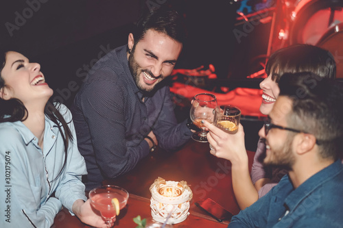 Принти на полотні Happy friends having fun in cocktail jazz bar - Young millennial people drinking
