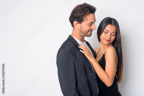 Portrait of multi ethnic business couple hugging each other