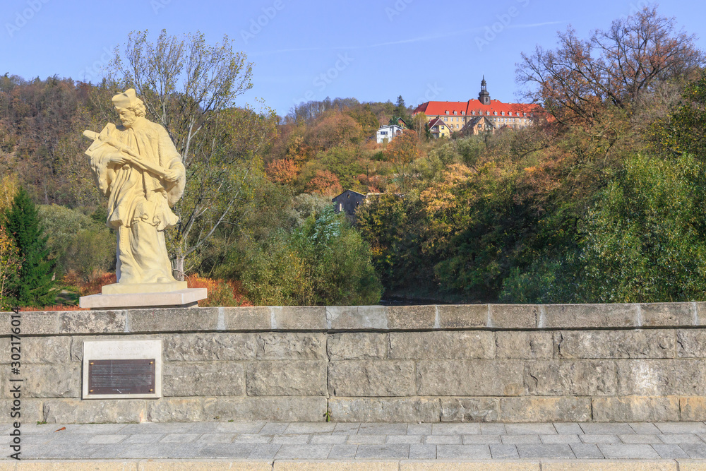Statue of St. John Nepomuk on  medieval gothic bridge through Nysa Klodzka in Bardo, Poland