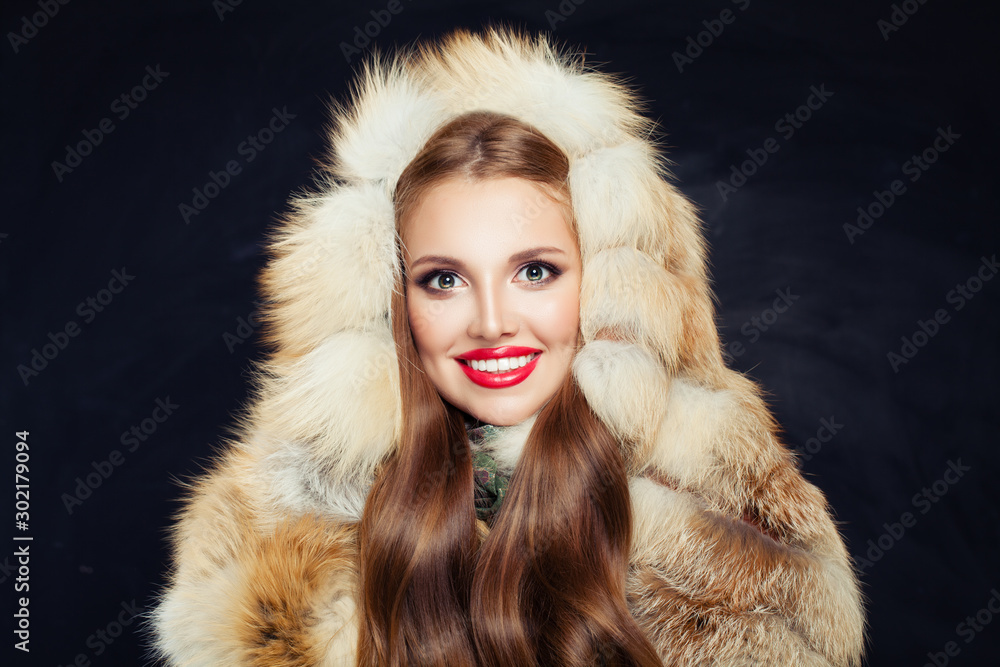 Beautiful winter girl in fur hood on black background Beautiful winter girl in fur hood on black background