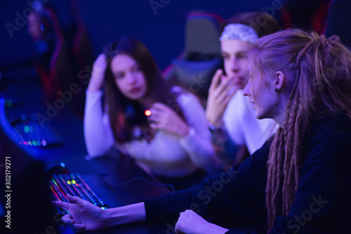 Team professional gamer Discuss strategy playing tournaments online games computer with headphones, red and blue color