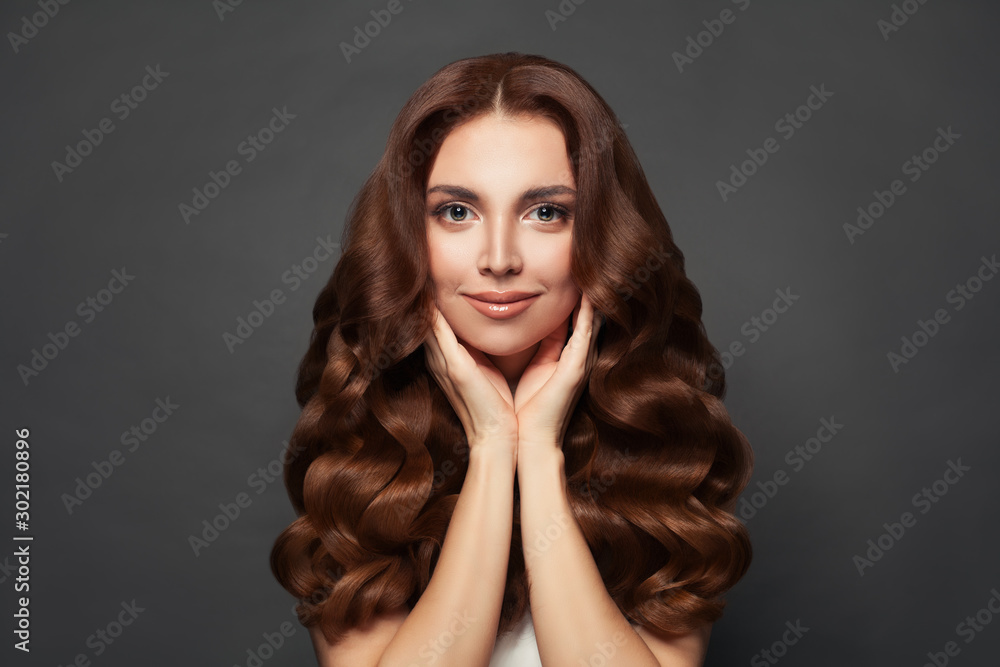 Foto de Beautiful cheerful woman with long curly hair. model