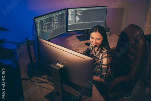Obraz na plátně Photo of hard-working software developer in headset smiling toothily looking int