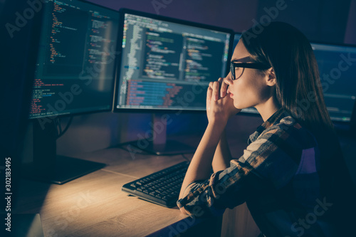 Photo of serious concentrated smart clever developer writing code for new video game to be released soon having to complete deadlines till morning