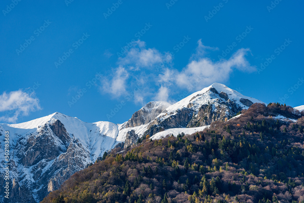 The Pichee, snow capped mountain in the Giudicarie Alps seen from the lake Tenno, Trento province, Trentino-Alto Adige, Italy, Europe
