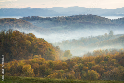 Layered misty landscape in late autumn photo