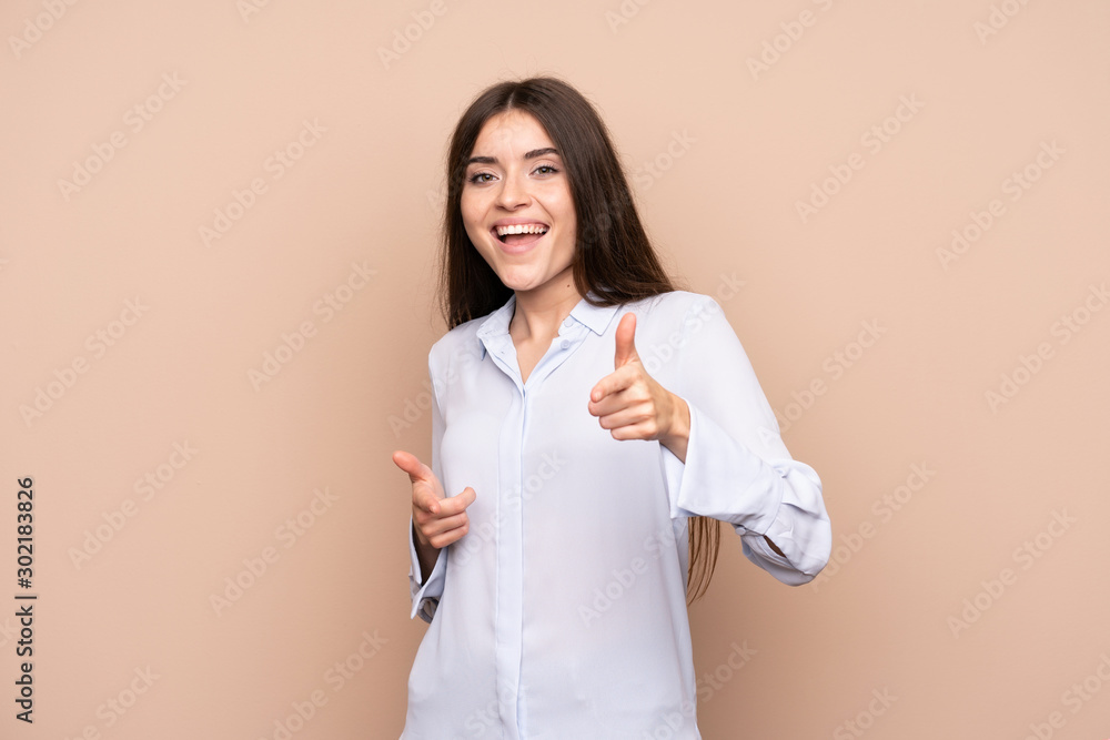 Young woman over isolated background pointing to the front and smiling Young woman over isolated background pointing to the front and smiling