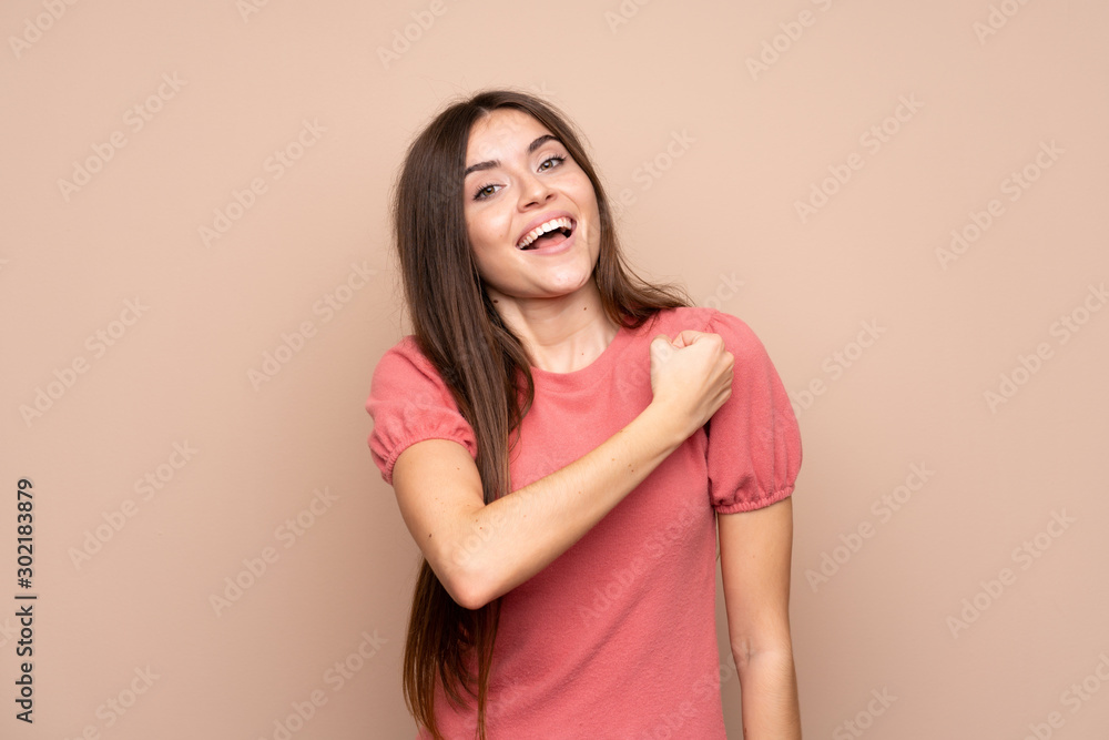 Young woman over isolated background celebrating a victory Young woman over isolated background celebrating a victory