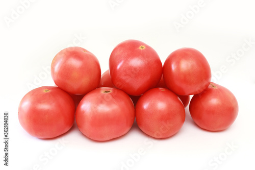 pink tomatoes on white background. vegetables