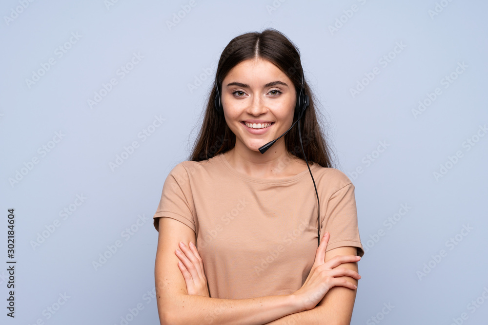 Young woman over isolated blue background working with headset Young woman over isolated blue background working with headset
