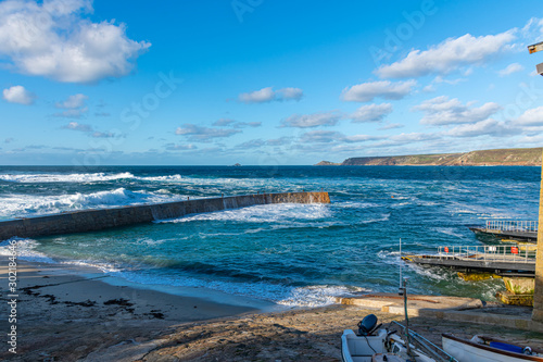 Sennen harbour, Cornwall, on a bright autumn day photo
