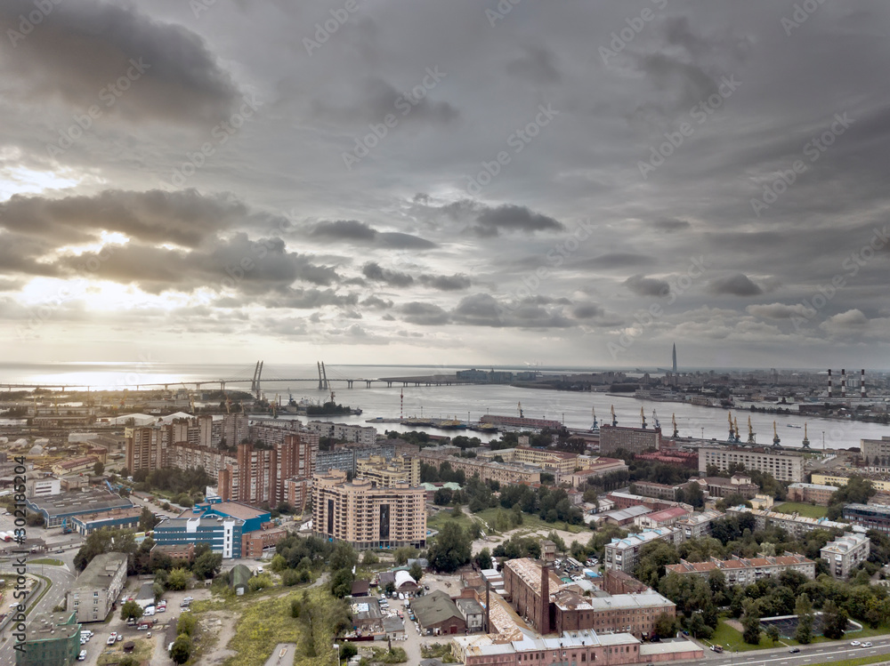 Drone view of the industrial part of St. Petersburg, Kanonersky island with Western high-speed diameter and the Gulf of Finland on the horizon