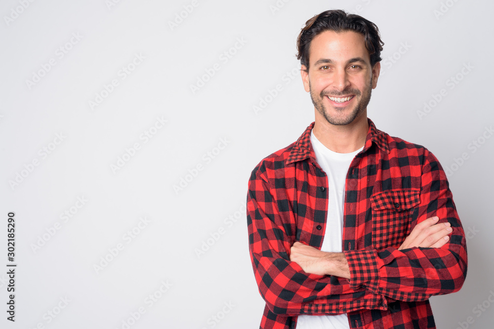 Portrait of happy Hispanic hipster man smiling with arms crossed Portrait of happy Hispanic hipster man smiling with arms crossed
