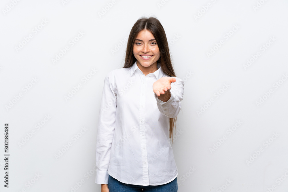 Young woman over isolated white background handshaking after good deal Young woman over isolated white background handshaking after good deal
