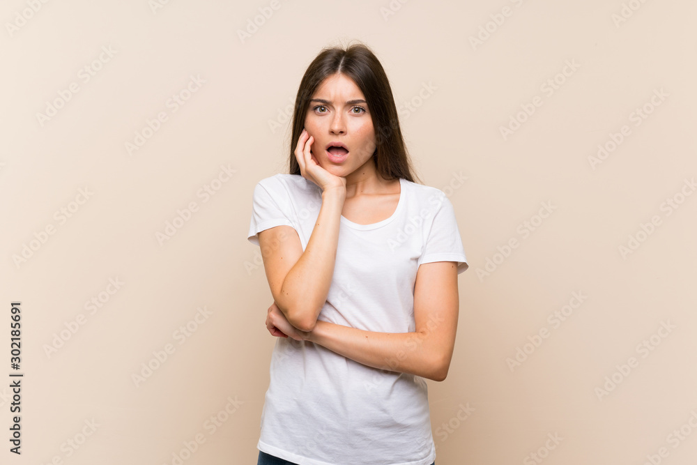 Pretty young girl over isolated background surprised and shocked while looking right Pretty young girl over isolated background surprised and shocked while looking right