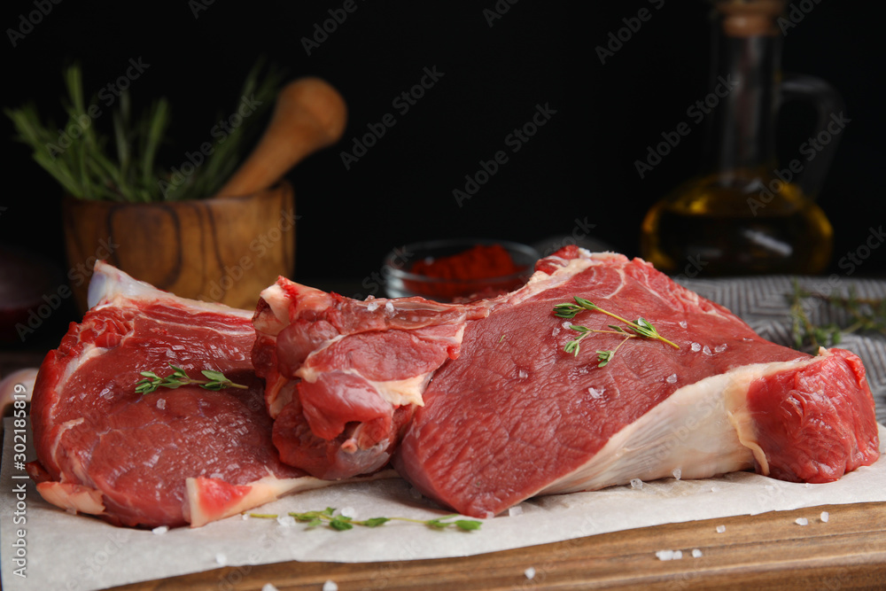 Fresh raw beef cut on wooden table, closeup
