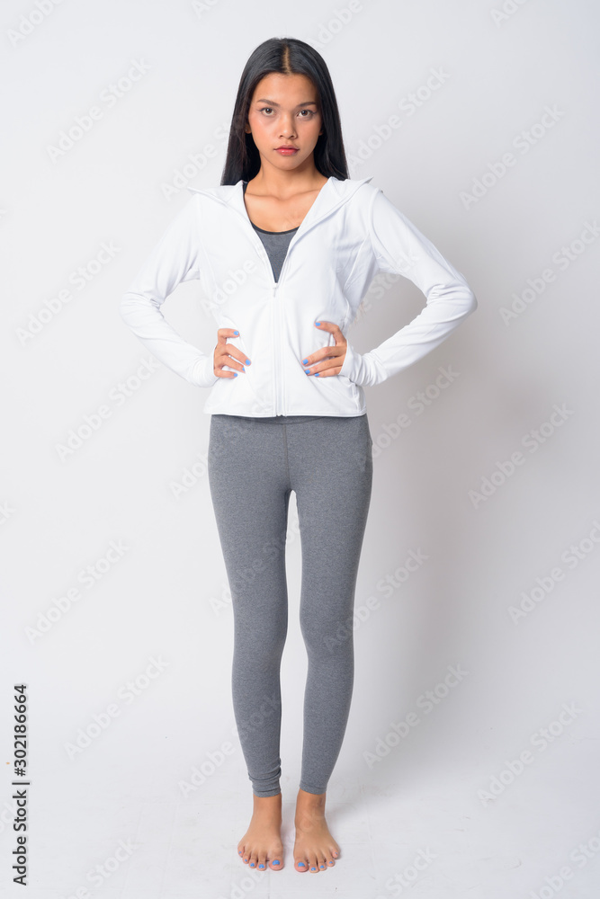 Full body shot of young Asian woman ready for gym Full body shot of young Asian woman ready for gym