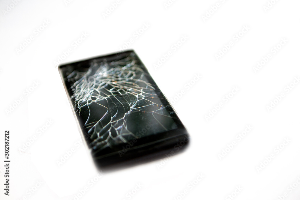 Broken phone glass. broken black smartphone. Close up on white background Broken phone glass. broken black smartphone. Close up on white background
