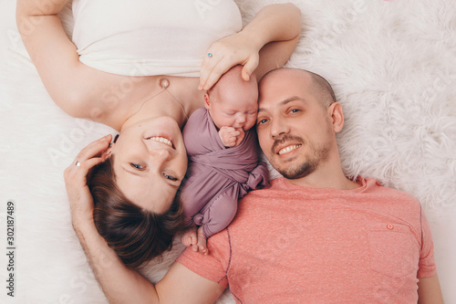family photo on a white background: parents spend time with their children. mom and dad hug the baby. the concept of childhood, fatherhood, motherhood, IVF