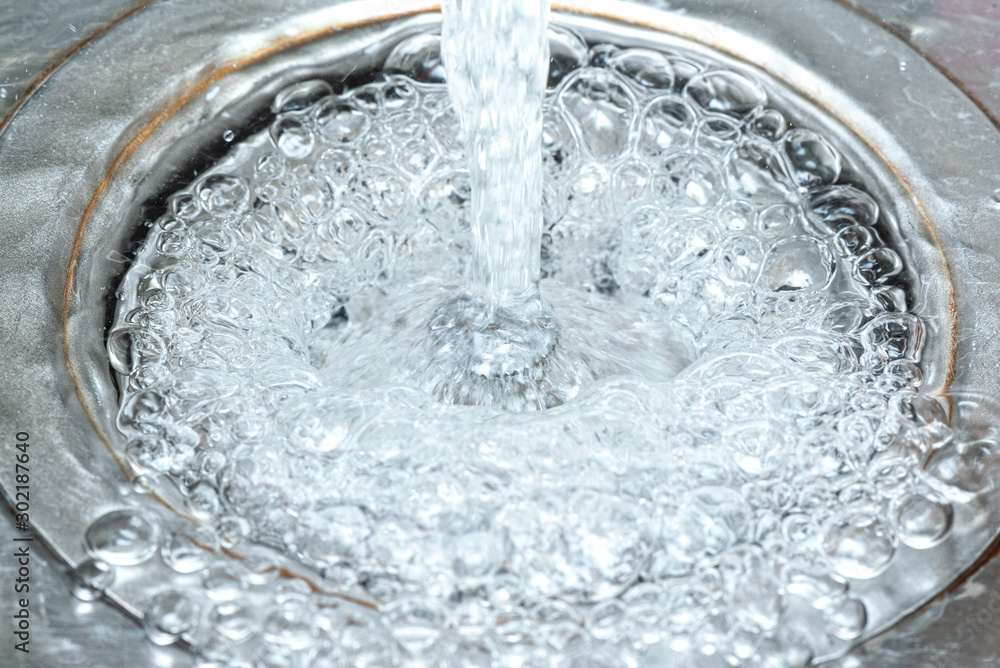 Water bubbles in the sink close up abstract background. Water bubbles in the sink close up abstract background.