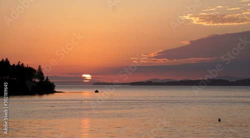 Breathtaking shot of the sunset across Penobscot Bay viewed from Northwest Harbor Deer Isle, Maine photo