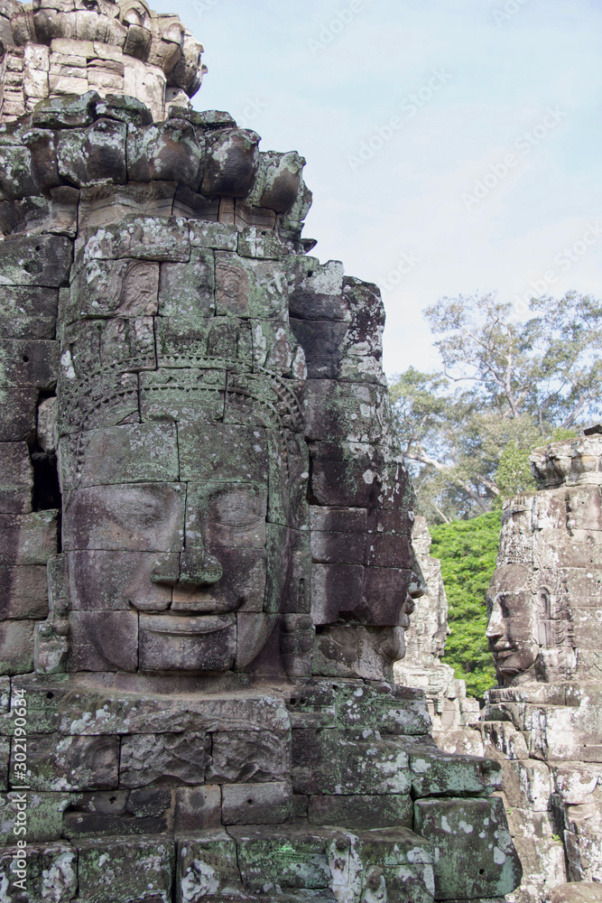 large buddha faces carved on angkor thom temple