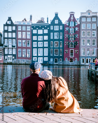 Photography Amsterdam city ,happy couple man and woman on a Autum evening at the canals, dut