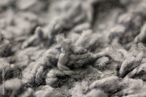 Macro photography of gray carpet long pile. Home textile interior close up