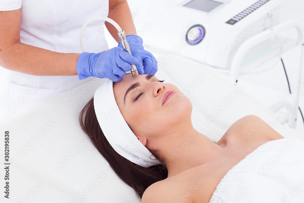 Woman in a beauty saloon making a facial treatment. Woman in a beauty saloon making a facial treatment.