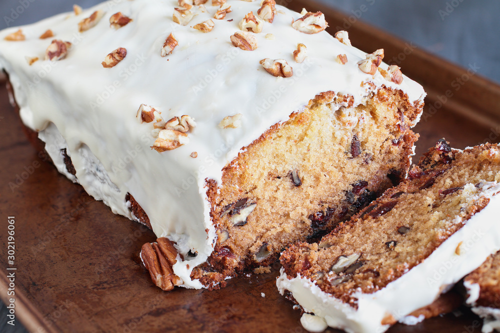 Fototapeta premium Homemade Cranberry Sweet Bread with Pecans and White Chocolate Candy Frosting