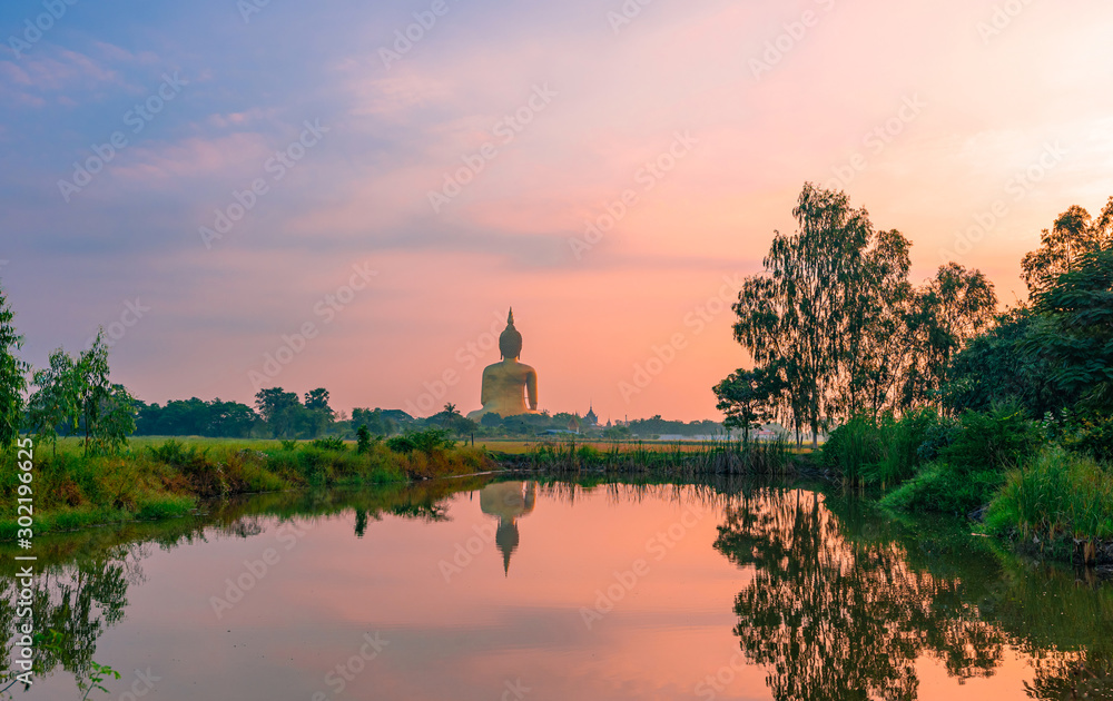 Fototapeta premium Sunrise at Big Buddha statue at Wat Muang, Ang Thong Province, Thailand.