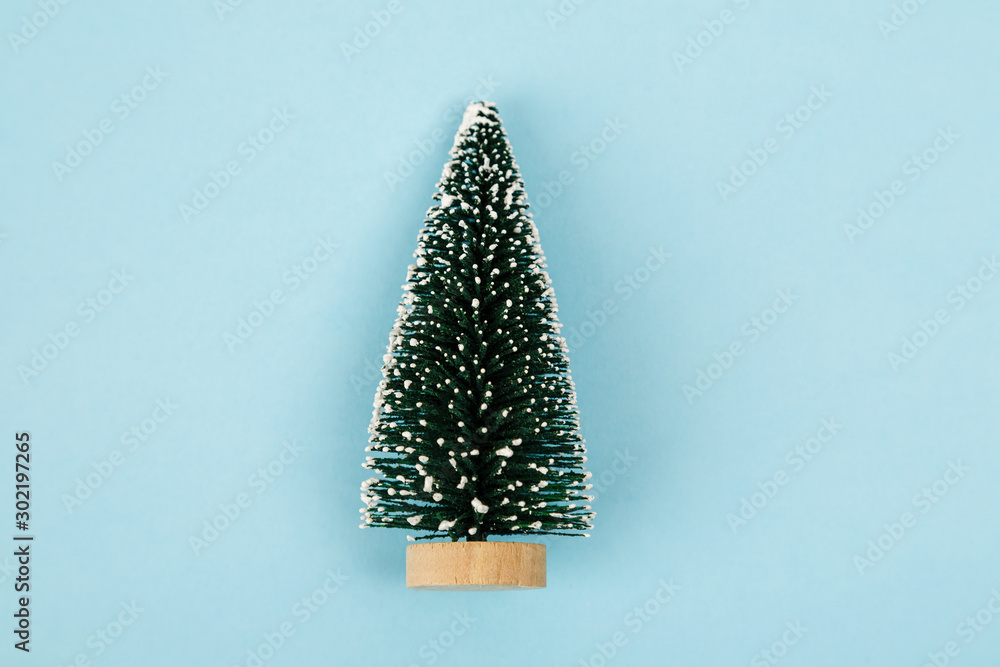 Small christmas tree on blue background