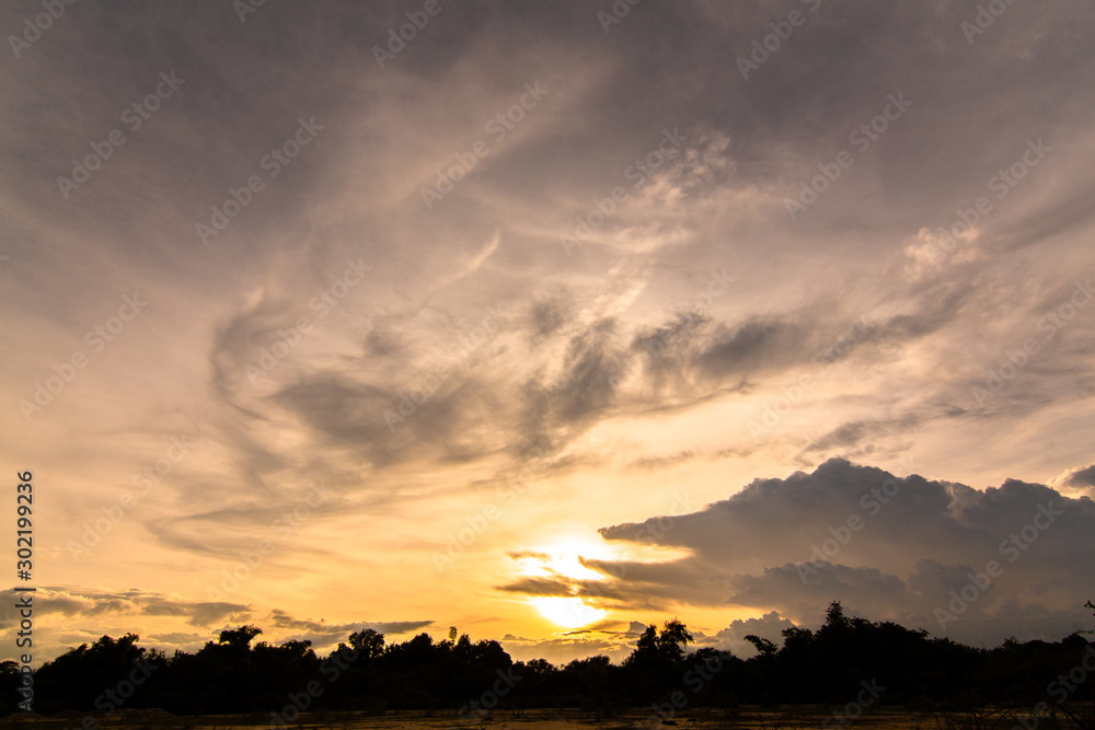 Fototapeta premium The clouds of black rain gathered in the evening. And evening light in Thailand