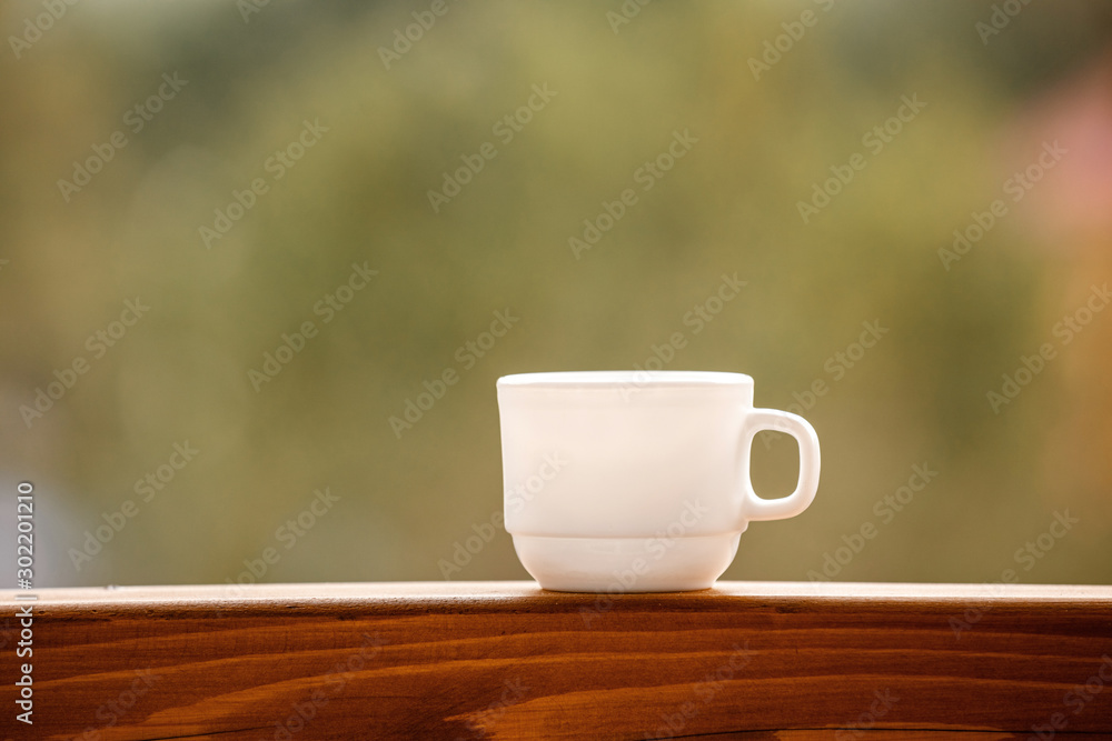 Coffee or tea in a cup on balcony with nature and mountain background in the morning Coffee or tea in a cup on balcony with nature and mountain background in the morning