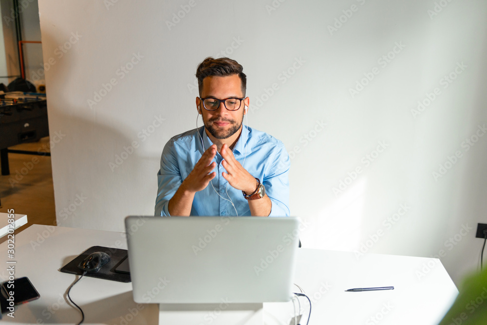 Young man sitting in his office	