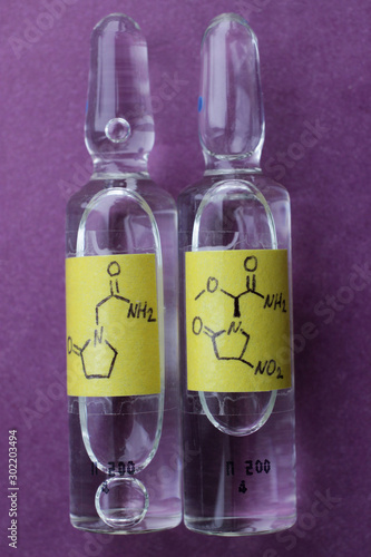 Two ampoules of medicines to improve memory on a purple background. photo