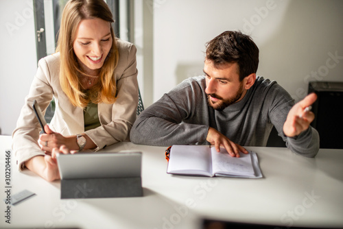 Two people working in office