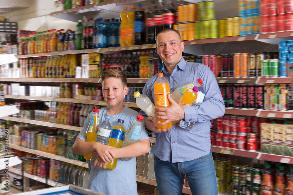 Portrait of joyful father and son with purchases