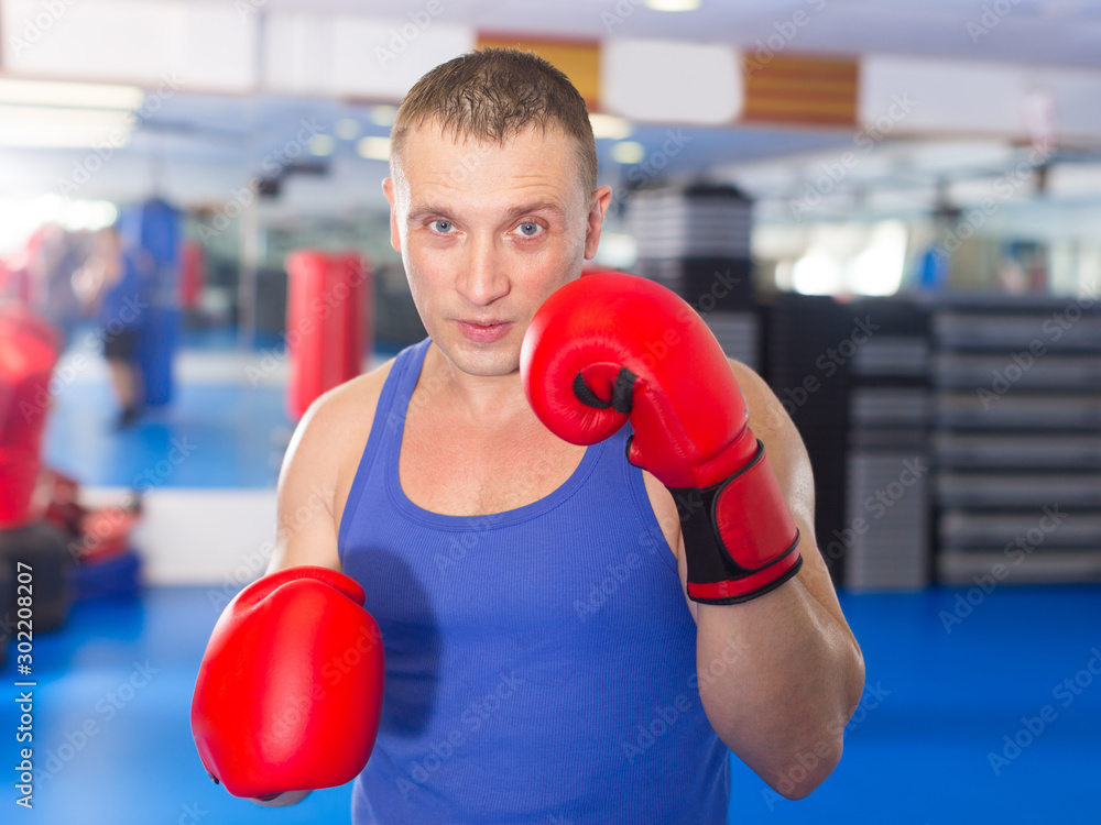 Portrait of ordinary male who is boxing