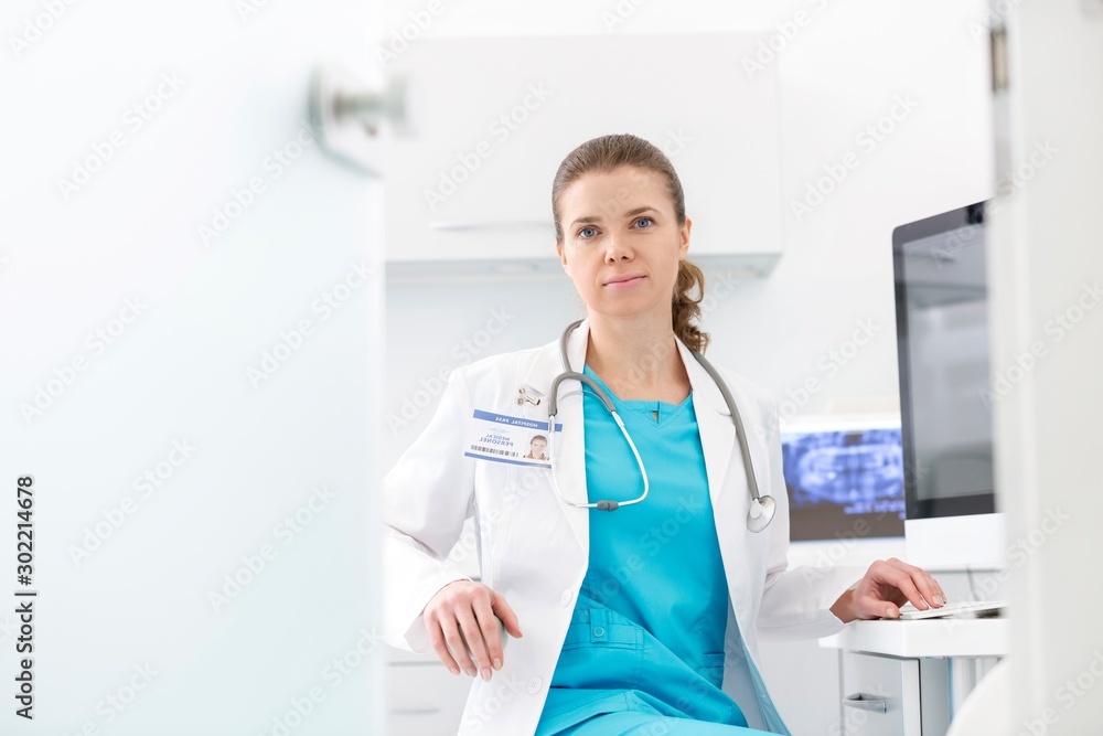 Confident dentist sitting in clinic Confident dentist sitting in clinic