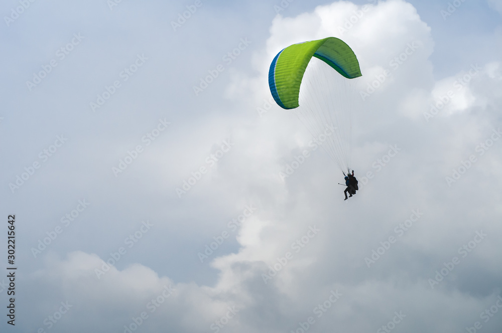 Two people on a paraglider, parachute the wing, fly in the clouds at the peak of the Carpathian mountains and shoot everything on video. Two people on a paraglider, parachute the wing, fly in the clouds at the peak of the Carpathian mountains and shoot everything on video.