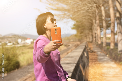 mature Asian woman take selfie