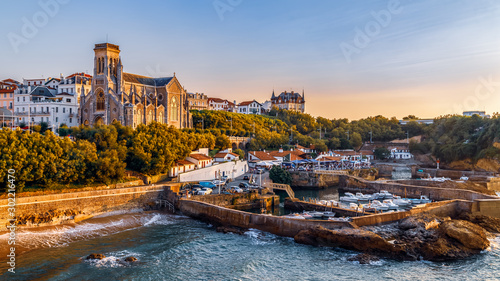 Panoramic view of Biarritz cityscape, coastline with its famous sand beaches and port for small boats. Golden hour. Aquitaine, France. photo