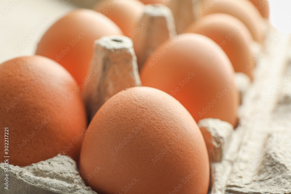 Chicken eggs in carton box as background, space for text Chicken eggs in carton box as background, space for text