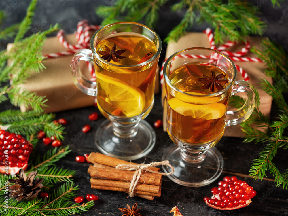 Christmas hot drink mulled wine on a festive table with fir tree branches and gift boxes Christmas hot drink mulled wine on a festive table with fir tree branches and gift boxes