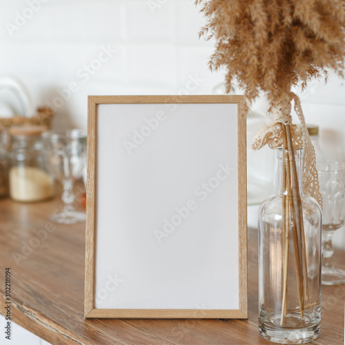 Wooden frame on the kitchen table in the interior.