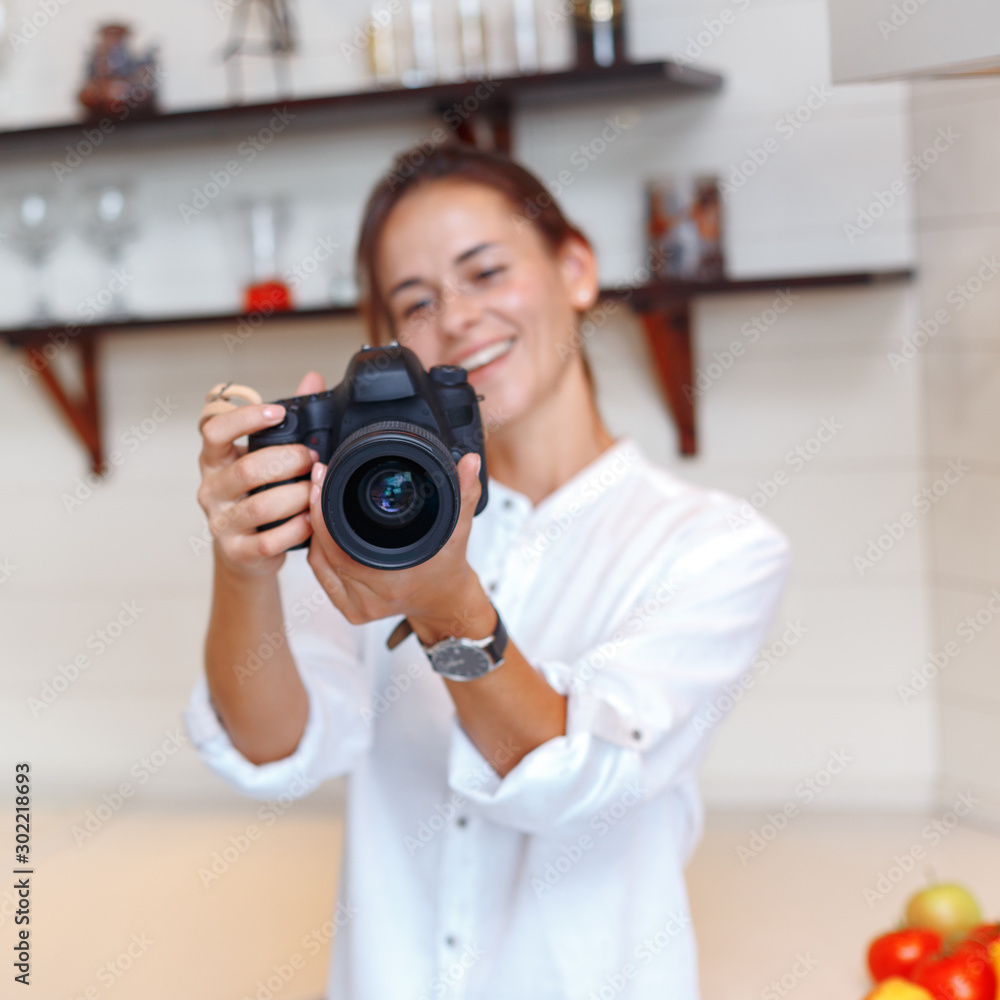 Young attractive girl photographs fruits with a camera Young attractive girl photographs fruits with a camera