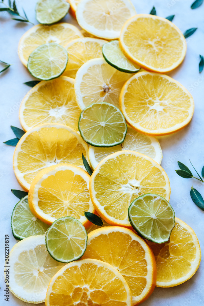 Orange, lemon and lime slices on a marble board Orange, lemon and lime slices on a marble board