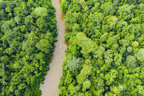 View from above, stunning aerial view of a tropical rainforest with the Sungai Tembeling River flowing through. Taman Negara National Park, located in Malaysia is the world's oldest rainforest.