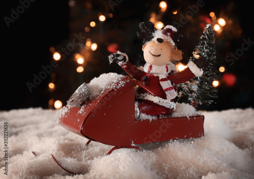 Happy rendeer in a red sled